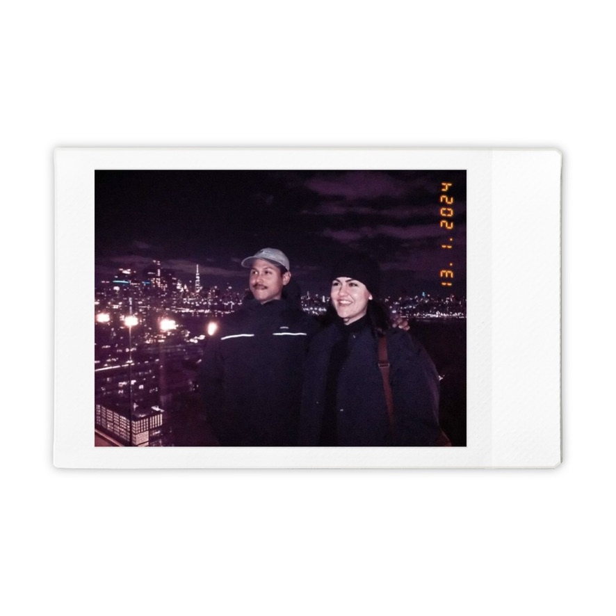 Mitra and Corey with the New York skyline at night, January 2024